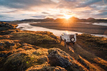 4x4 Truck looks out over sunrise landscape in Iceland - CAVF82963