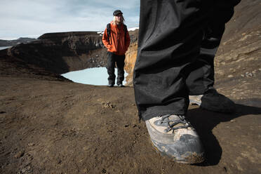 Couple hiking up from the Askja caldera in the Icelandic highlands - CAVF82984