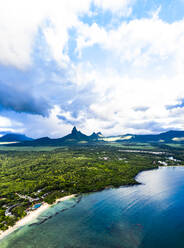 Mauritius, Black River, Flic-en-Flac, Helicopter view of clouds over oceanside village in summer with Trois Mamelles range in background - AMF08125