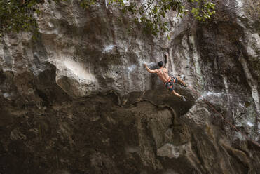 One tattooed man with no shirt rock climbing in Mexico - CAVF83046