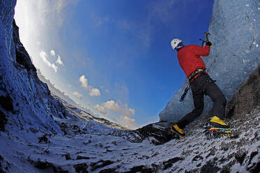 Mature man climbing at Solheimajokull in south Iceland - CAVF83212