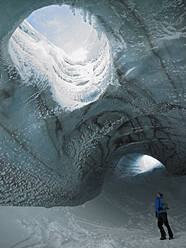 Man exploring ice cave in Iceland - CAVF83217