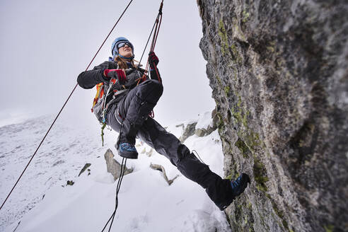Mature woman climbing at Grossvendediger, Tyrol, Austria - PNEF02588