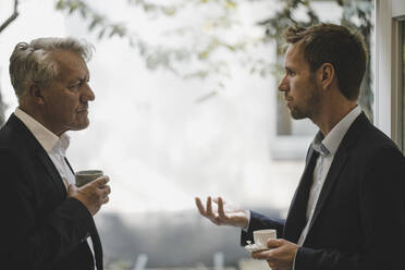 Two businessmen discussing in office - GUSF03818