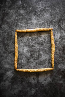 Studio shot of Italian grissini breadsticks arranged into square shape - GIOF08229