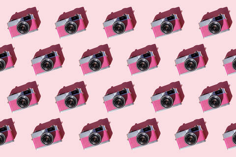 Seamless pattern of rows of vintage analog cameras stock photo