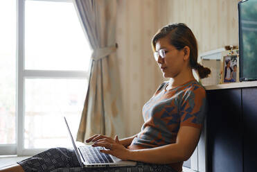 Frau benutzt Computer-Laptop für Arbeit von zu Hause aus - CAVF83315