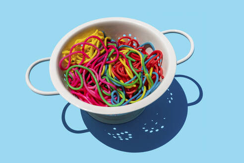 Studio shot of colorful pasta in colander - GEMF03777