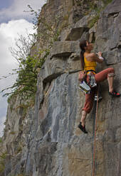 Female climber on a difficult climb in the Wye Valley / south Wales - CAVF83631