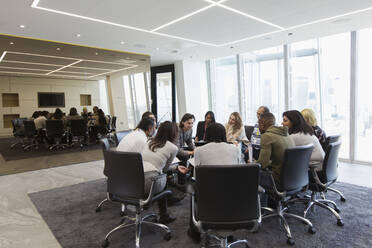Business people meeting in circle in conference room - CAIF27551
