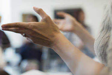 Close up businesswoman gesturing in meeting - CAIF27645