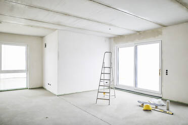 Room with ladder on construction site - MJFKF00223