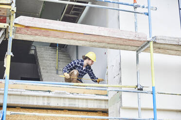 Worker working on a construction site - MJFKF00246