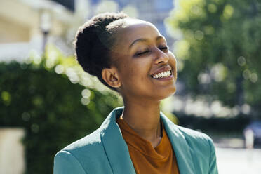 Portrait of young businesswoman with eyes closed outdoors - MFF05787