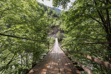 Georgia, Wooden suspension bridge stretching over river - WVF01685