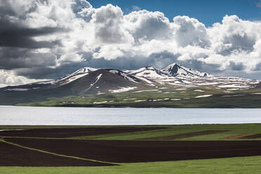 Georgia, Samtskhe-Javakheti, Poka, Large white clouds over alpine lake - WVF01698