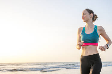 Woman running at the sea, Gran Canaria, Spain - DIGF12564