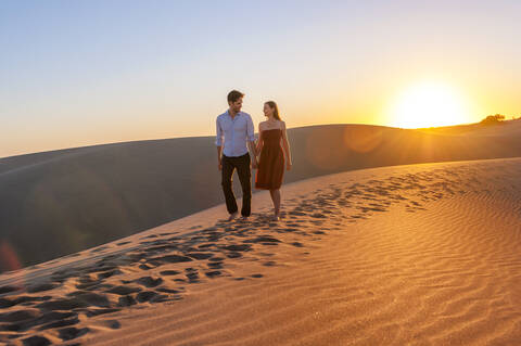 Couple walking at sunset in the dunes, Gran Canaria, Spain stock photo