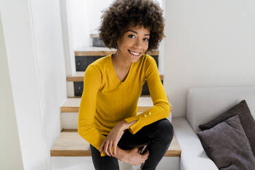 Portrait of smiling young woman at home - GIOF08260