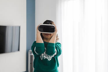Young woman with down syndrome using VR glasses at home - DCRF00242
