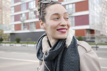 Smiling beautiful woman with white rats on scarf against building - EYAF01096