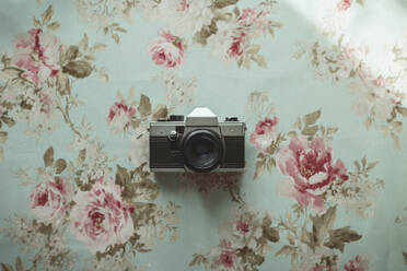 Old camera on a flowered background - CAVF83877