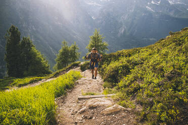 Man hiker going up to Aiguillette des Posettes, French Alps, Chamonix - CAVF84059