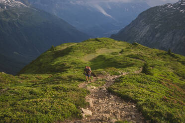 Young male hikes up to Aiguillette des Posettes, Chamonix, France - CAVF84060