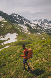 Young male hiking in the French alps between France and Switzerland - CAVF84071