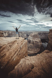 Woman in Horseshoe Bend point at sunset - CAVF84231