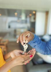 Close up man handing house keys to woman - HOXF06348