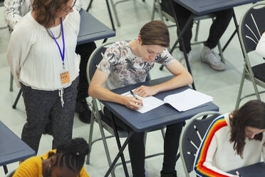 Gymnasiallehrer beaufsichtigt Schüler, die im Klassenzimmer eine Prüfung ablegen - CAIF28006