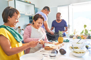 Glückliches reifes Paar Freunde kochen in der Küche - CAIF28096