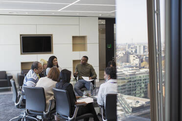 Business people talking in circle in conference room meeting - CAIF28137