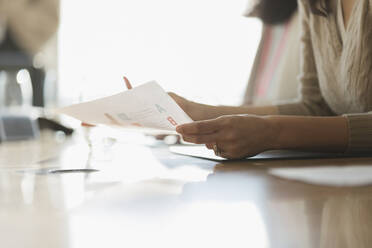 Businesswoman with paperwork in conference room meeting - CAIF28141