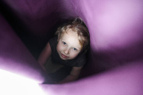 Cute girl hiding in curtain at home - EYAF01122