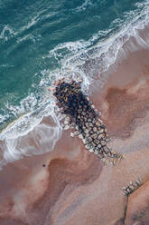 Aerial view of rocks on the beach shore in Bournemouth, UK - AAEF08683