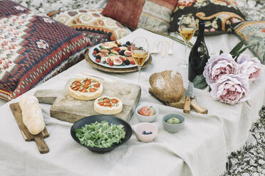 High angle view of various food with wine with flowers on table - ALBF01252