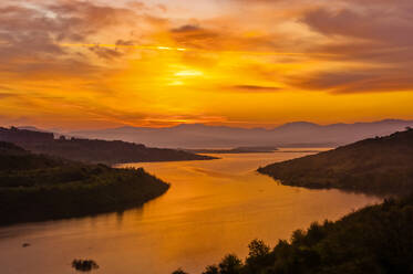 Sunset over Lake Omodeo, an artificial lake in central west Sardinia, Italy. - CUF55512