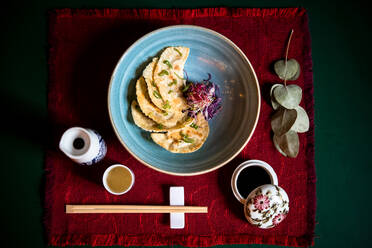 High angle close up of a selection of dishes in a Ramen and Gyoza restaurant in Italy. - ISF24214