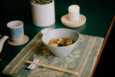 High angle close up of bowl of soup with dumplings in a Ramen and Gyoza restaurant in Italy. - ISF24217