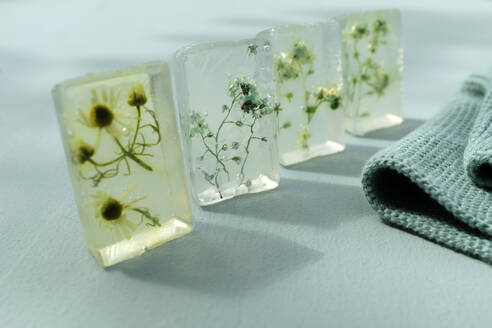 Various wildflowers cast in transparent bars of glycerine soaps - GISF00595