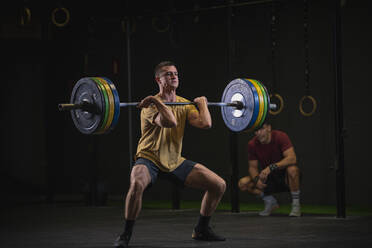 Man doing overhead squat exercise at gym - SNF00269