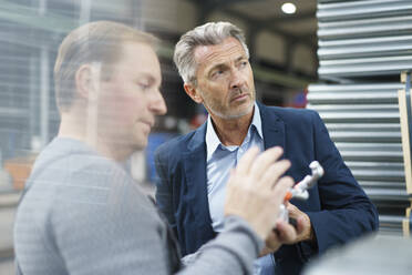 Businessman and worker in a factory - MOEF02947