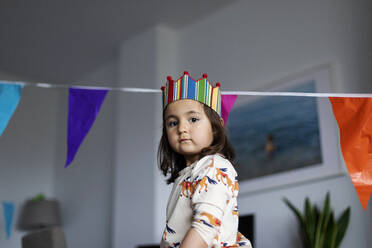 Portrait of serious little girl celebrating birthday at home - VABF03016