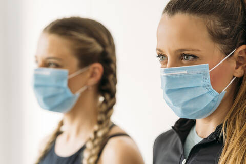 Portrait of two sporty women wearing face masks stock photo