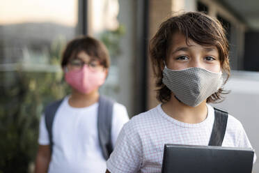 Siblings wearing masks outdoors - VABF03063