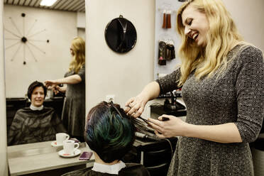 Female hairdresser cutting woman's hair - JATF01193