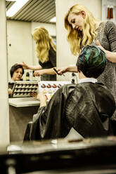Hairdresser showing colour samples to colour hair - JATF01196