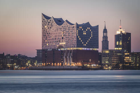 Germany, Hamburg, Heart shape displayed on Elbphilharmonie at dusk - KEBF01538